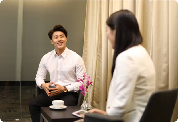 Executive single man talking to dating consultant in Lunch Actually Singapore office